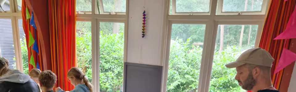 Kinderen knutselen aan tafel in de zaal