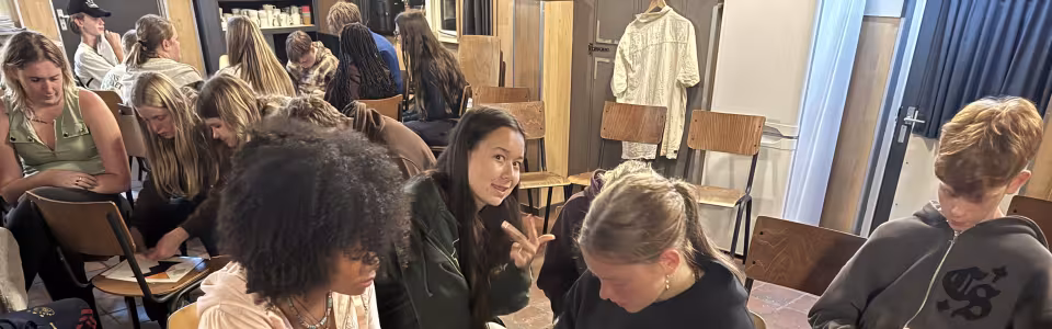 Deelnemers aan tafel in het kampgebouw