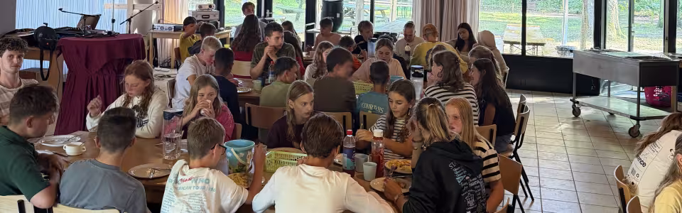Deelnemers aan tafel in een versierde zaal