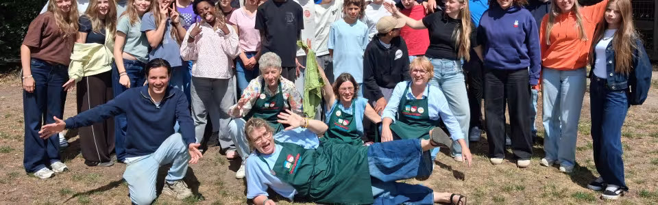 Grote groepsfoto van deelnemers in het gras