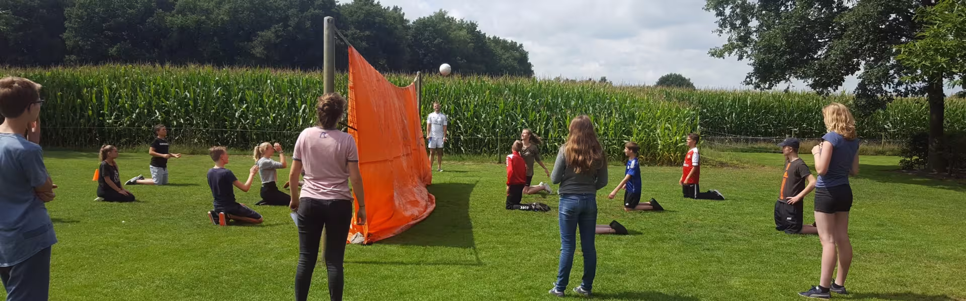 Buitenspellen op een grasveld met een oranje vlag