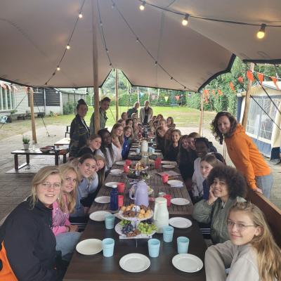 Deelnemers aan lange gedekte tafels in de tent