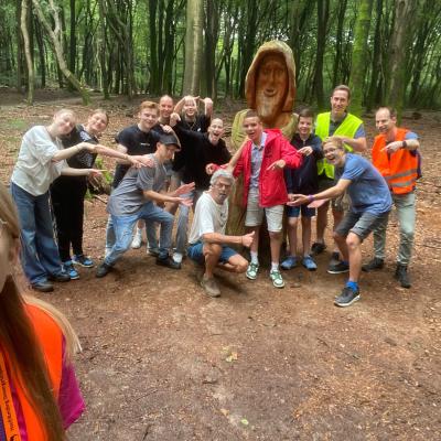 Deelnemers poseren op een bospad